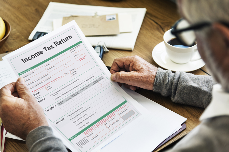 elderly man reviewing income tax return